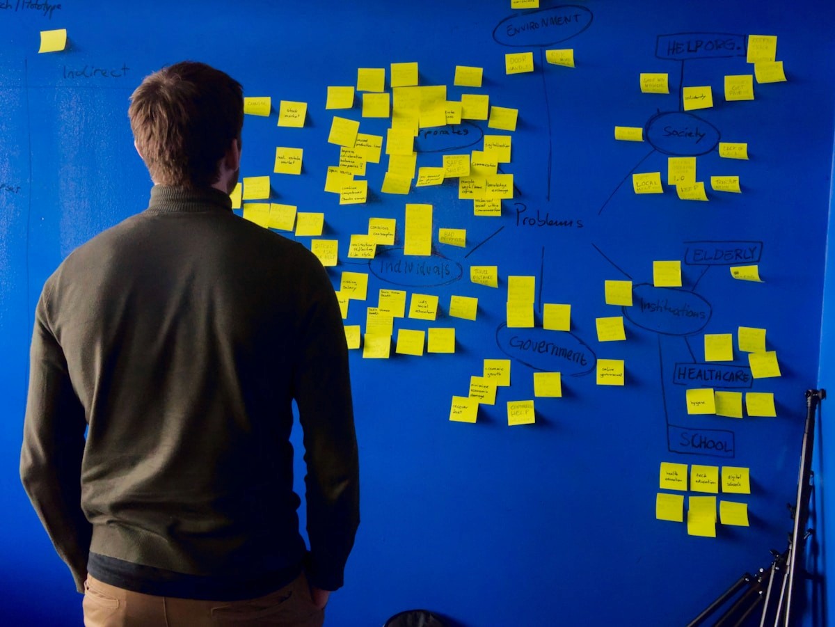 Person planning content on a wall of sticky notes
